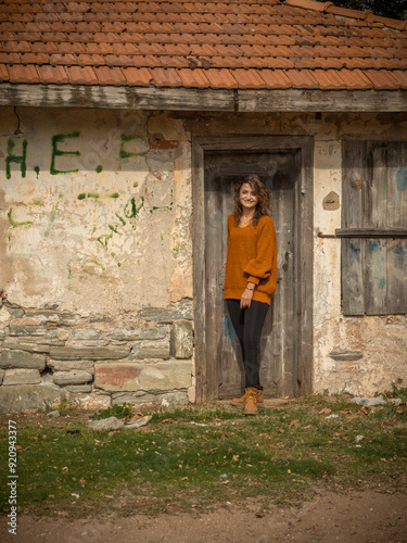 Portrait of pretty young girl in front of stone house