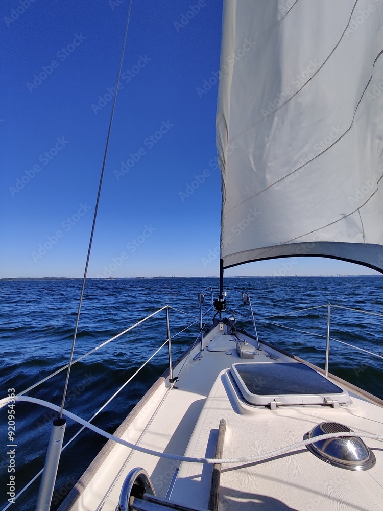 Fototapeta premium Luxury cruise on a sailing rigged yacht under a genoa and mainsail sailing in a light wind during the regatta. Yachting as a luxury sport and great vacation