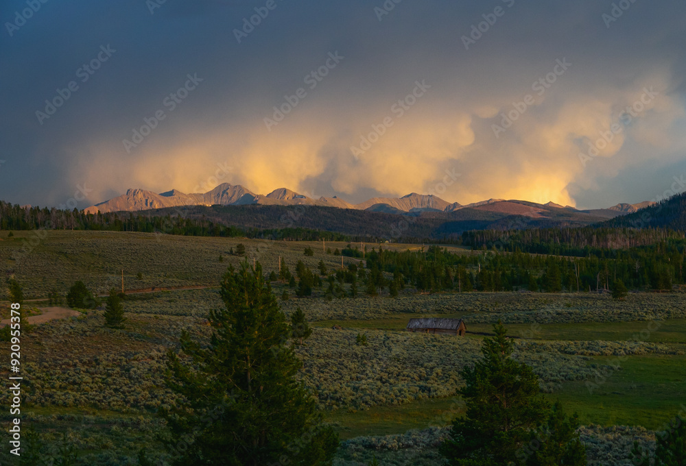beautiful clouds over the mountains with green pastures in the foreground beautiful clouds over the mountains with green pastures in the foreground