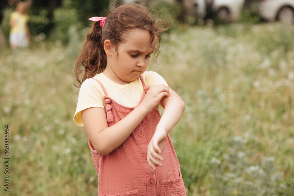 Little cute girl suffering from mosquito bites in the park Little cute girl suffering from mosquito bites in the park