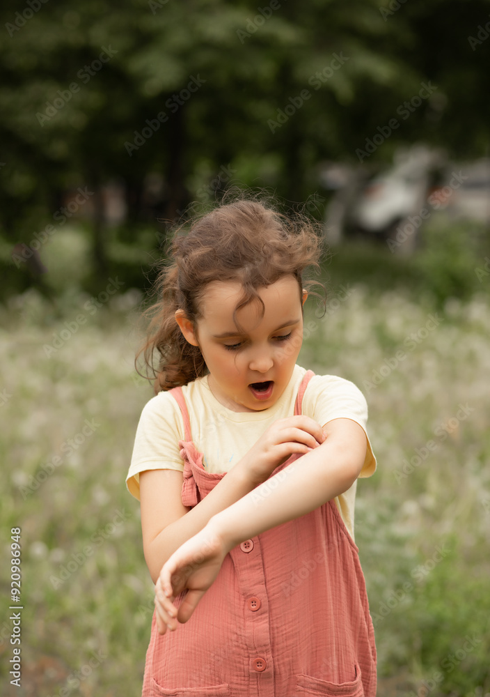 Little cute girl suffering from mosquito bites in the park Little cute girl suffering from mosquito bites in the park