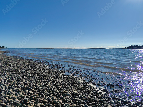 Mutila beach in Medlin resort in Croatia. Beautiful pebbels and blue sea and sky photo