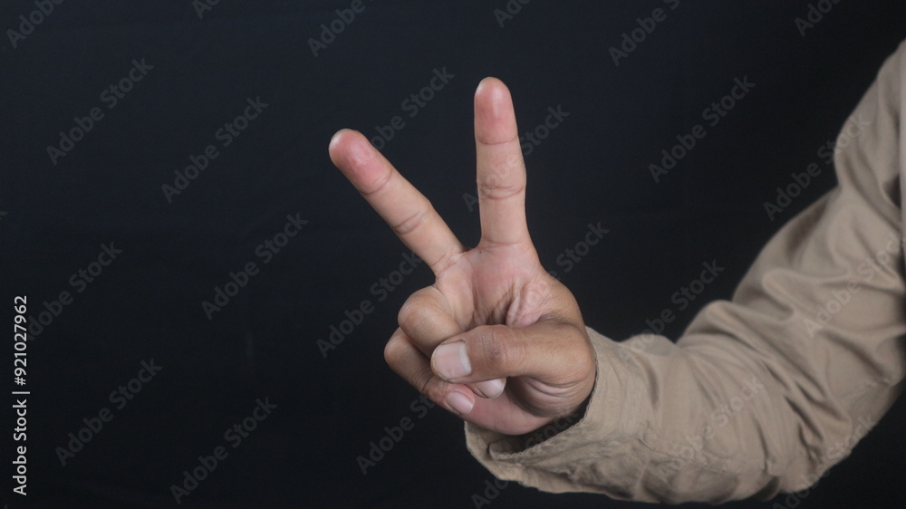 business man hand with two fingers count gesture, isolated on black background business man hand with two fingers count gesture, isolated on black background