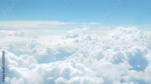 A breathtaking view of fluffy white clouds against a clear blue sky, evoking tranquility.