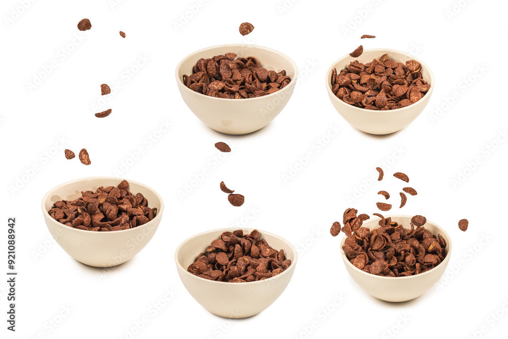Chocolate corn flakes falling to the white bowl isolated on white. Motion. Chocolate corn flakes falling to the white bowl isolated on white. Motion.