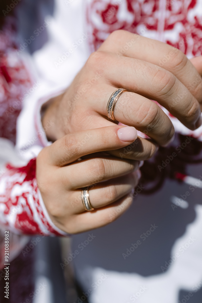 Fototapeta premium Close-up of hands with wedding rings.