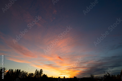 The sky, a canvas painted with strokes of ethereal pink, stretched across the horizon, casting a warm, rosy glow upon the tranquil landscape. As the sun dipped below the distant horizon.