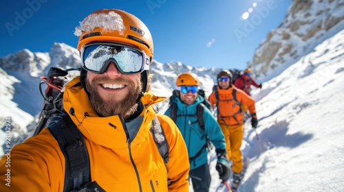 Wallpaper Mural A group of hikers, all wearing bright yellow and orange winter gear, are seen equipped with skis and hiking on a snowy mountain path, ready for a downhill adventure. Torontodigital.ca