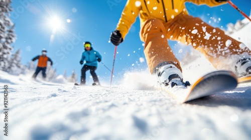 A group of skiers in vibrant ski suits skiing down a snowy slope with bright sunlight, snow spraying in all directions, capturing the essence of speed and enthusiasm. photo