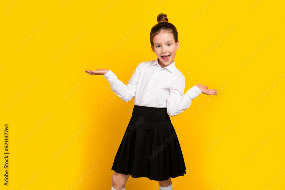 Photo of cute schoolgirl arms hold empty space scales wear uniform isolated on yellow color background Photo of cute schoolgirl arms hold empty space scales wear uniform isolated on yellow color background