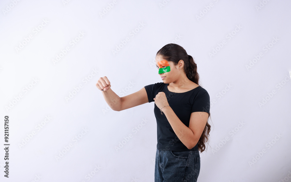 Portrait of cheerful young woman fan with face painted cheering for indian sports team, celebrating Independence day or Republic day. Portrait of cheerful young woman fan with face painted cheering for indian sports team, celebrating Independence day or Republic day.