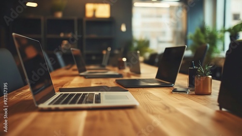 Wallpaper Mural Modern Workspace: Sleek laptops sit open on a long wooden conference table, creating a minimalist and inviting atmosphere for collaboration and productivity.   Torontodigital.ca
