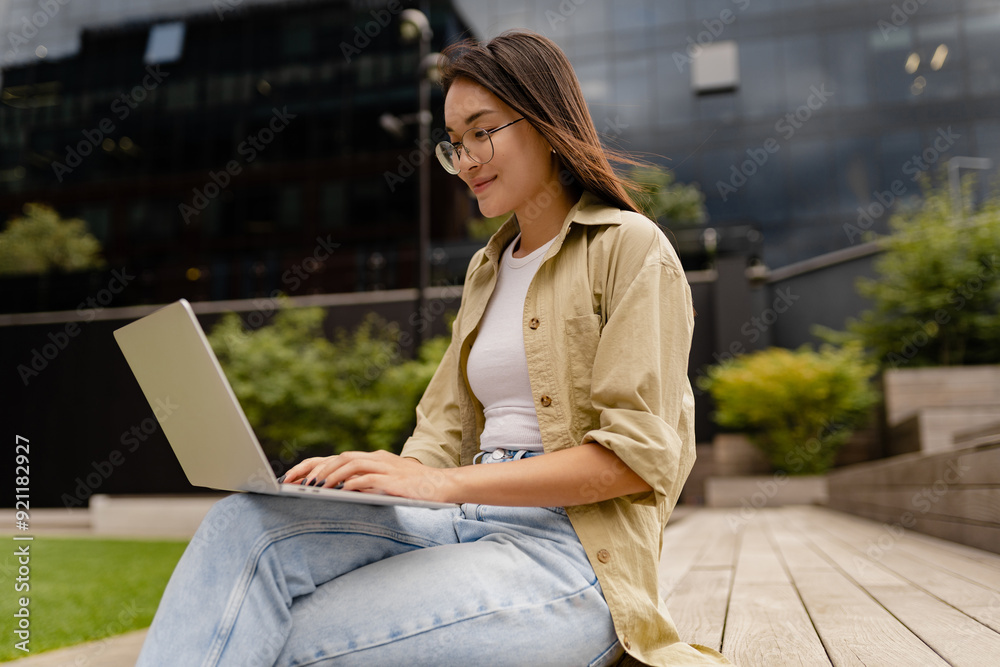 young pretty woman sitting in student campus co-working outside young pretty woman sitting in student campus co-working outside