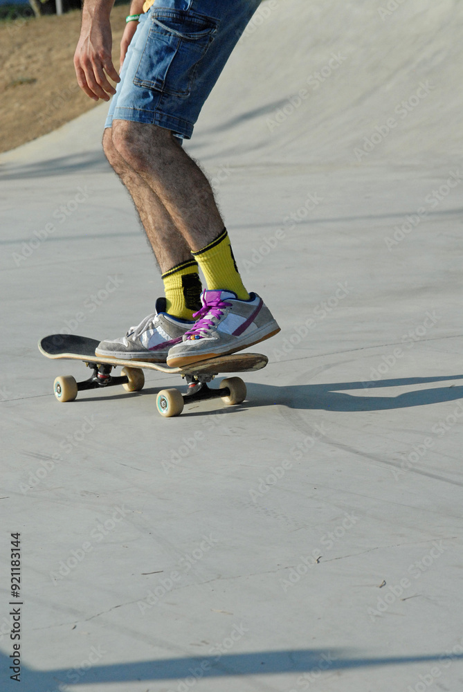 Skateboard detail boy legs on outdoors park background. Skateboard detail boy legs on outdoors park background.