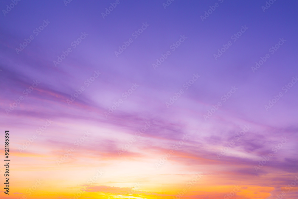 Colorful clouds and sky. Dusk and sunset. Evening clouds with orange, yellow, pink and red sunlight and amazing storm clouds in the dusk sky.