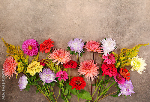 Abstract floral composition flat lay. Flowers dahlias, asters, buttercups on old concrete background, autumn banner for advertising products, rustic style, holiday card