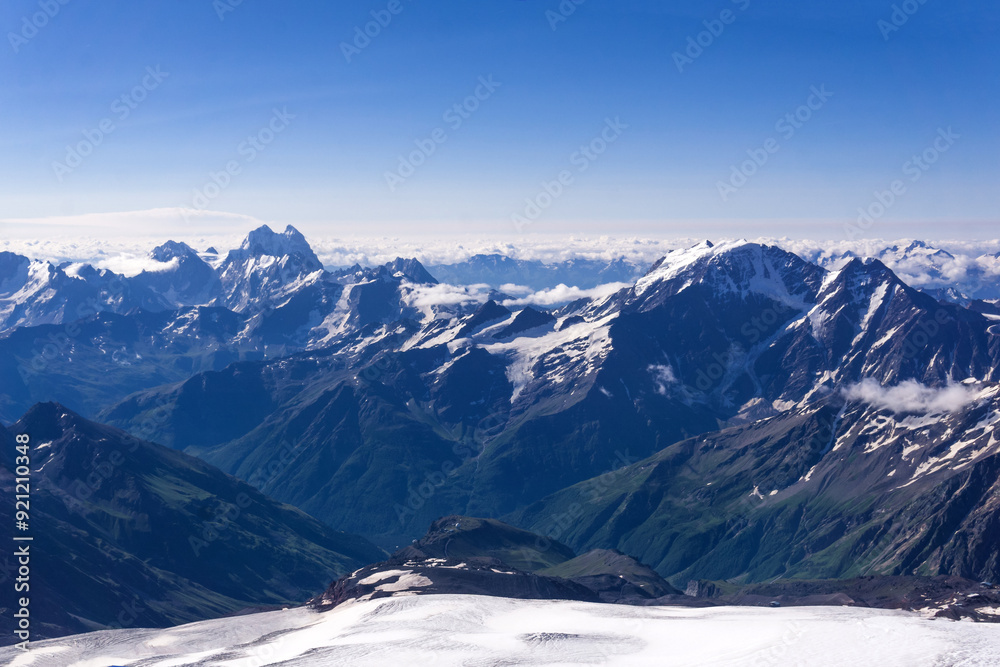 mountain landscape, view from highland snow slope to green valleys, view from Mount Elbrus to the Main Caucasian Range mountain landscape, view from highland snow slope to green valleys, view from Mount Elbrus to the Main Caucasian Range
