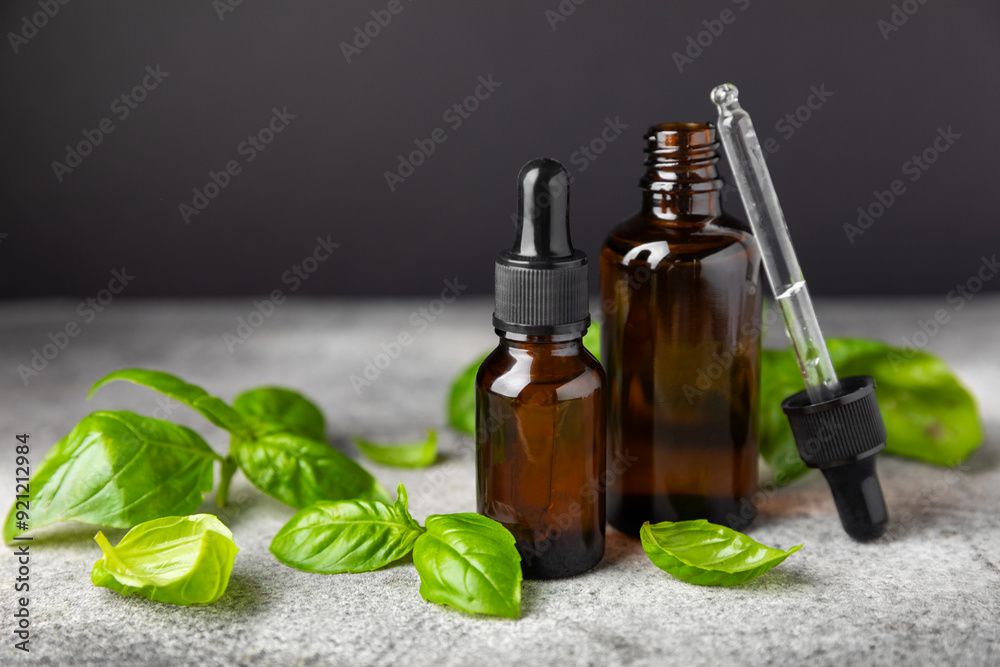 Basil essential oil on a textured wooden background. Basil essential oil and fresh leaves. Aromatherapy. Aroma oil. Medical herbs. Alternative medicine. Place for text. Copy space. Basil essential oil on a textured wooden background. Basil essential oil and fresh leaves. Aromatherapy. Aroma oil. Medical herbs. Alternative medicine. Place for text. Copy space.