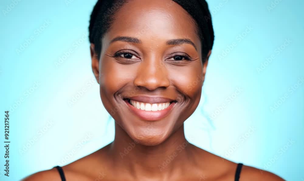 Closeup portrait of a beautiful african american woman smiling over blue background Closeup portrait of a beautiful african american woman smiling over blue background
