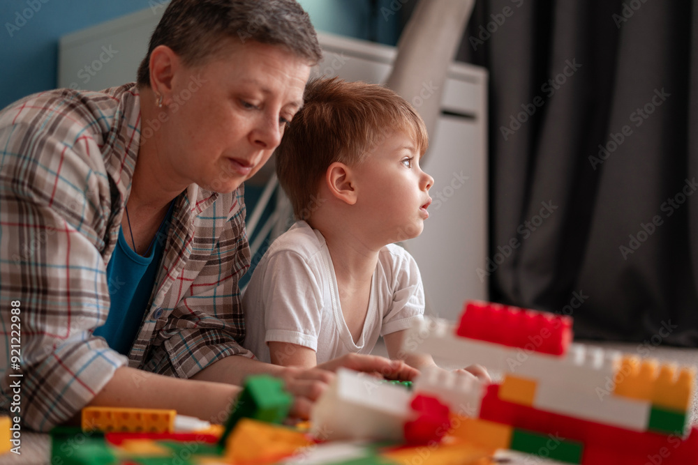 Mother and Son Building Toy Blocks Together in Living Room Mother and Son Building Toy Blocks Together in Living Room