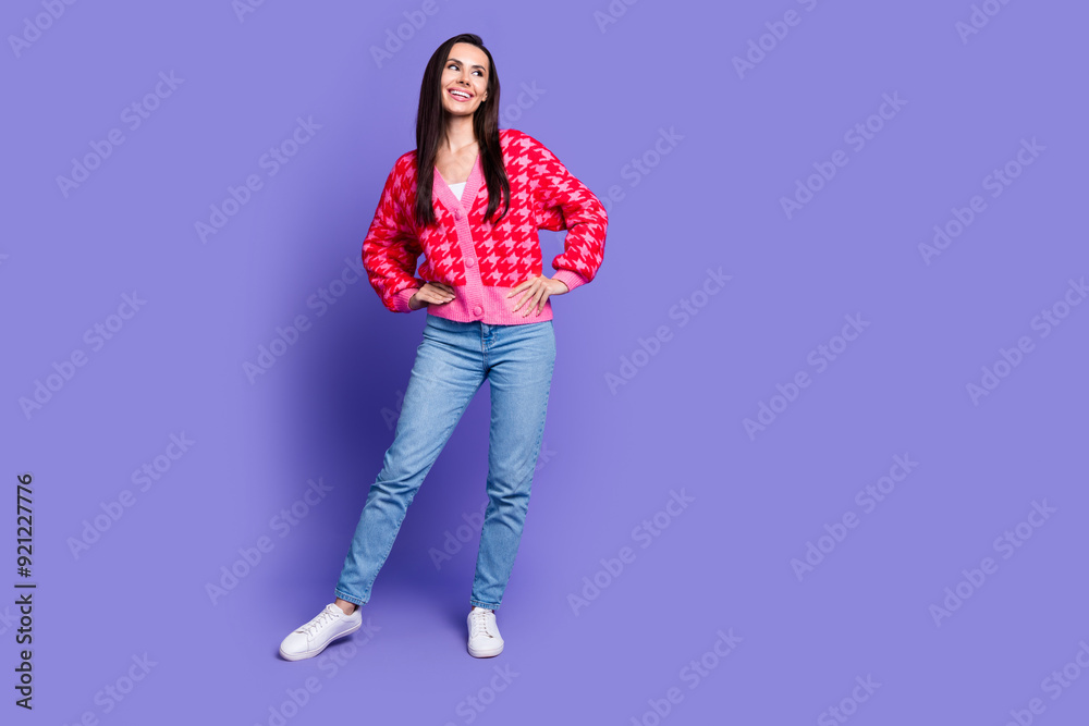 Full length photo of adorable lovely girl wear pink cardigan smiling looking empty space isolated purple color background Full length photo of adorable lovely girl wear pink cardigan smiling looking empty space isolated purple color background