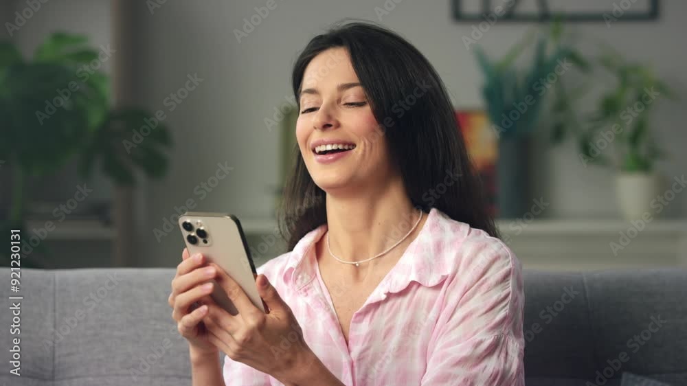 Woman sitting comfortably on couch, engaging in video call Woman sitting comfortably on couch, engaging in video call