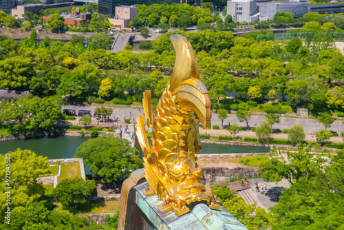 Osaka Castle Shachihoko (sea monster) on main keep roof. Osaka Castle is a Japanese castle in Chuo ward in historic city of Osaka, Japan. It's one of the most famous castle in Japan.  photo