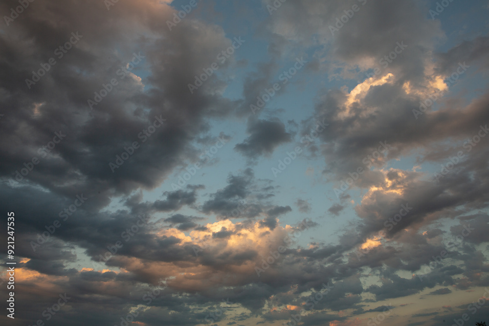 Obraz premium Cloudscape, Colored Clouds at Sunset near the Ocean in a Cloudy Day