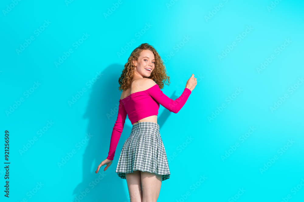 Rear portrait of nice young girl write empty space blackboard wear top isolated on turquoise color background Rear portrait of nice young girl write empty space blackboard wear top isolated on turquoise color background