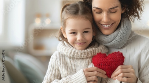 Mother and Daughter Smiling Together Holding a Red Heart in Bright Kitchen