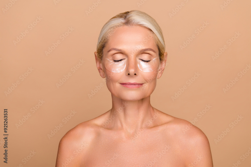 Photo portrait of lovely elderly lady fresh perfect anti aging treatment smiling beauty shoulders off isolated on beige color background Photo portrait of lovely elderly lady fresh perfect anti aging treatment smiling beauty shoulders off isolated on beige color background