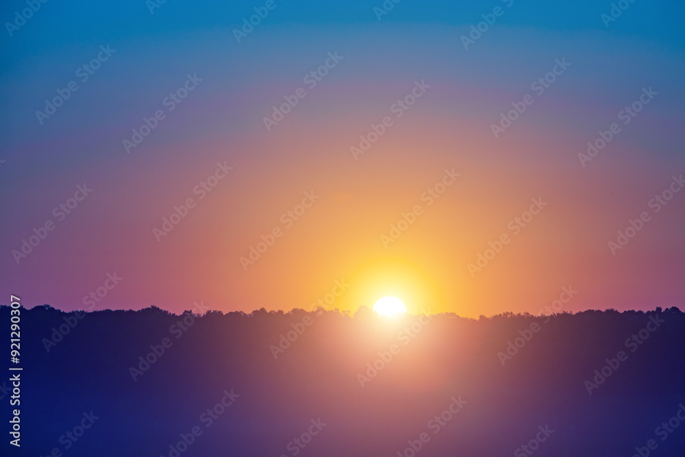 A beautiful sunset with a bright orange sun in the sky A beautiful sunset with a bright orange sun in the sky