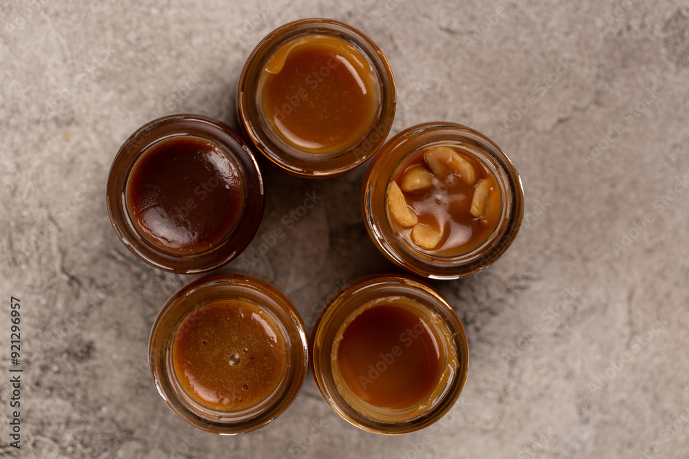 Homemade caramel with different flavors in glass jars Homemade caramel with different flavors in glass jars