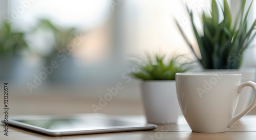 Cozy Workspace With Pink Mug and Tablet Surrounded by Green Plants
