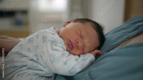 Sleeping newborn baby resting on parent's chest, dressed in a patterned onesie, peaceful and content expression, intimate family moment, cozy indoor setting, soft and warm atmosphere