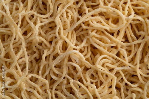 Chinese egg noodle,Thin yellow noodles covered by flour for texture background