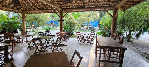 Canvas Print wooden tables and chairs in outdoor eating area