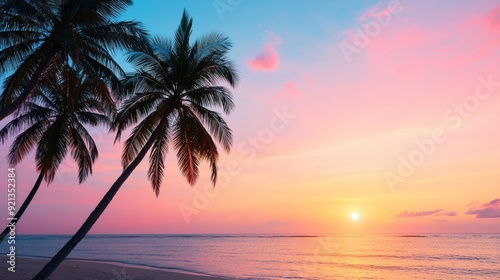 A serene beach at sunset, with palm trees silhouetted against the sky