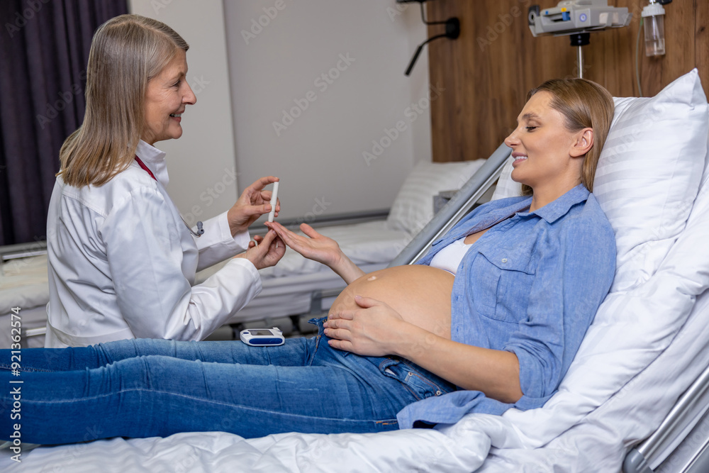 Fototapeta premium Doctor measuring pregnant womans level of glucose with glucometer