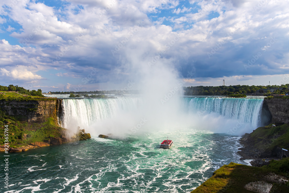 Canadian side view of Niagara Falls, Horseshoe Falls and a boat tours in a sunny summer day in Niagara Falls, Ontario, Canada Canadian side view of Niagara Falls, Horseshoe Falls and a boat tours in a sunny summer day in Niagara Falls, Ontario, Canada