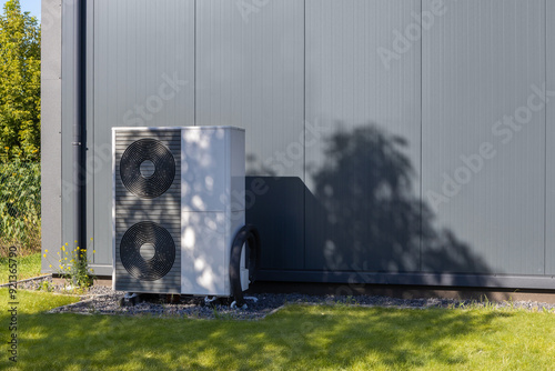 Modern Heat Pump Against Industrial Building Exterior