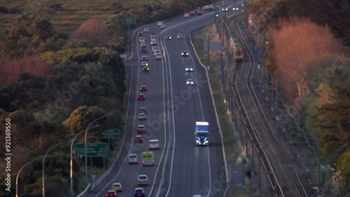 Soft focus time-lapse highway traffic and suburban train, New Zealand