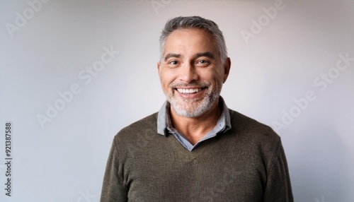 a 60-year-old man looking happy on a white backdrop