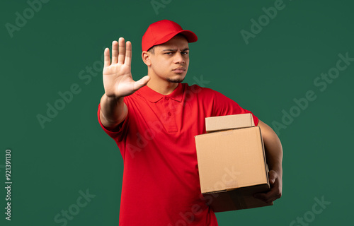 Serious disagreeable Post Courier Man disapproving with no hand sign. Disagree guy on green.
