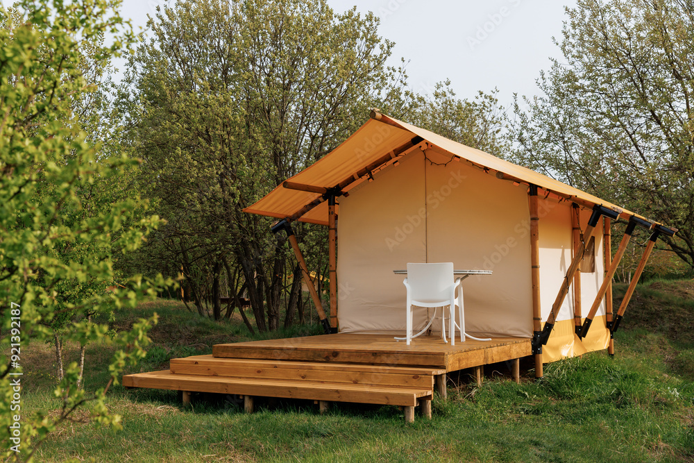 Cozy open glamping tents with light inside in summer camp. Camping tent for holiday and vacation Cozy open glamping tents with light inside in summer camp. Camping tent for holiday and vacation