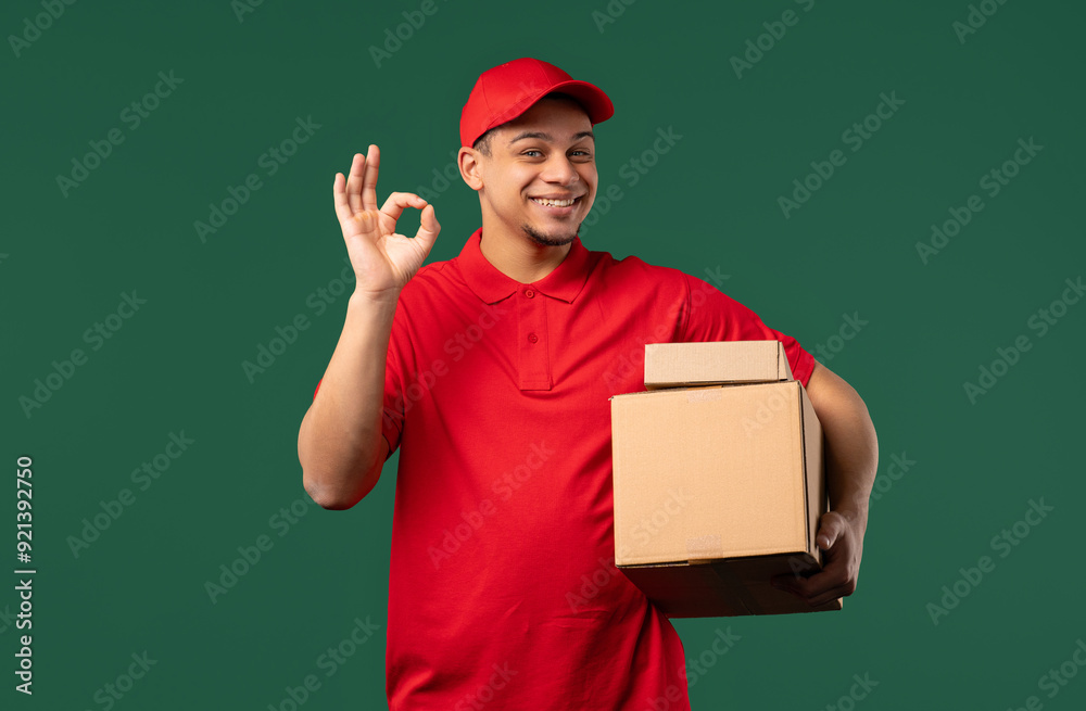 Positive postal courier man with hands sign OK, okay. Happy postman on green. Positive postal courier man with hands sign OK, okay. Happy postman on green.