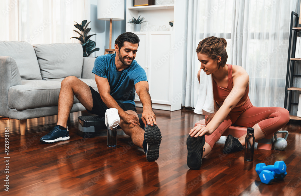 Athletic body and sporty young couple or workout buddy in sportswear warmup or resting after finishing in home workout exercise at gaiety home exercise and healthy lifestyle concept. Athletic body and sporty young couple or workout buddy in sportswear warmup or resting after finishing in home workout exercise at gaiety home exercise and healthy lifestyle concept.