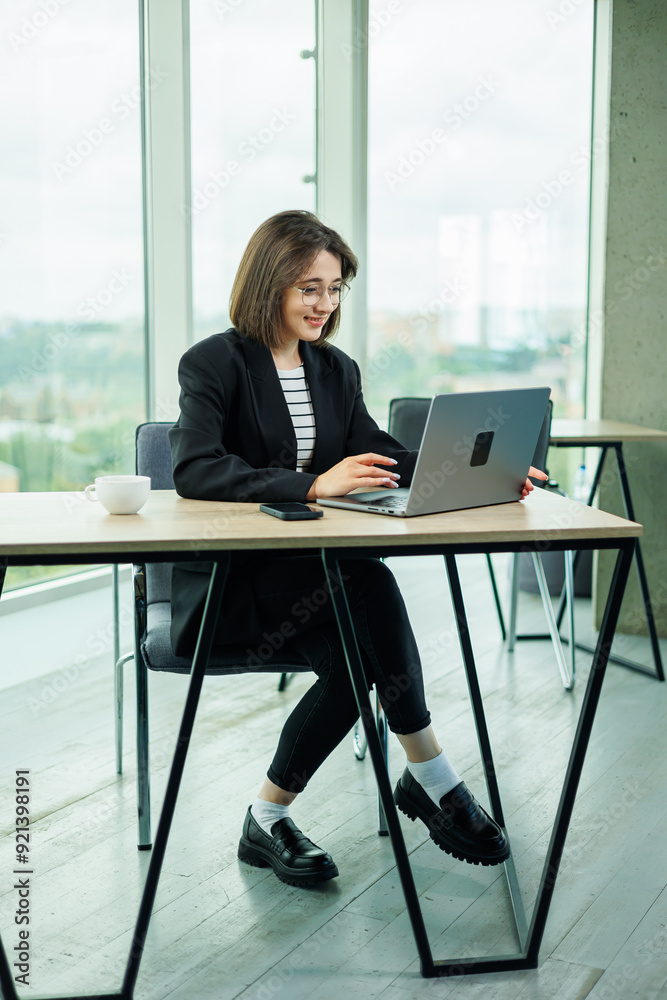 Young woman working in a spacious office. Successful people are working on a new business project. Collective work in the office Young woman working in a spacious office. Successful people are working on a new business project. Collective work in the office