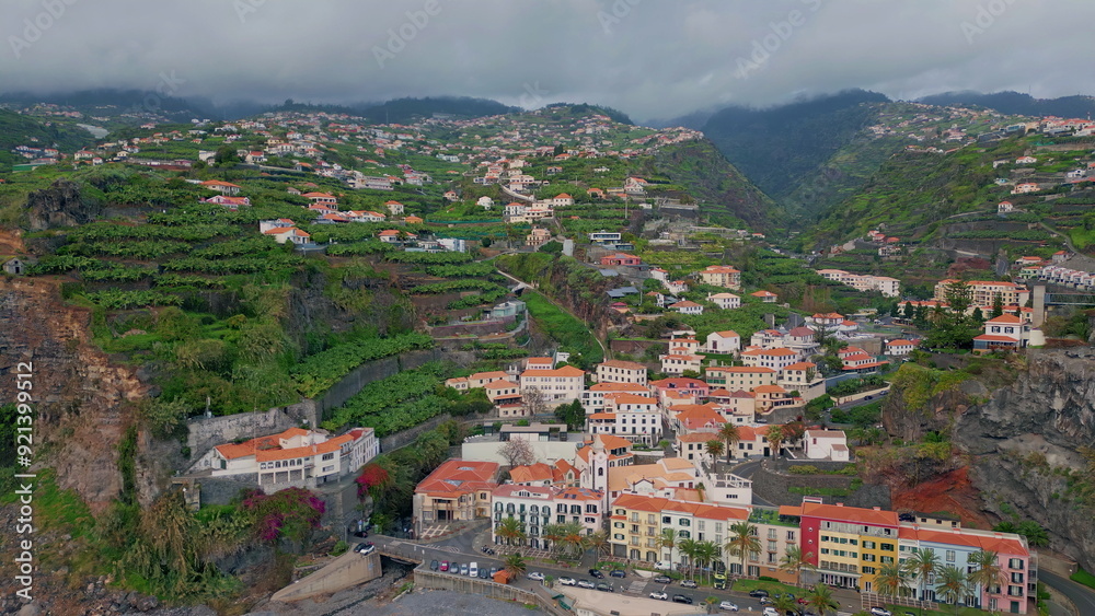 Fototapeta premium Aerial view coastal village with red roofs. Beautiful Madeira travel destination