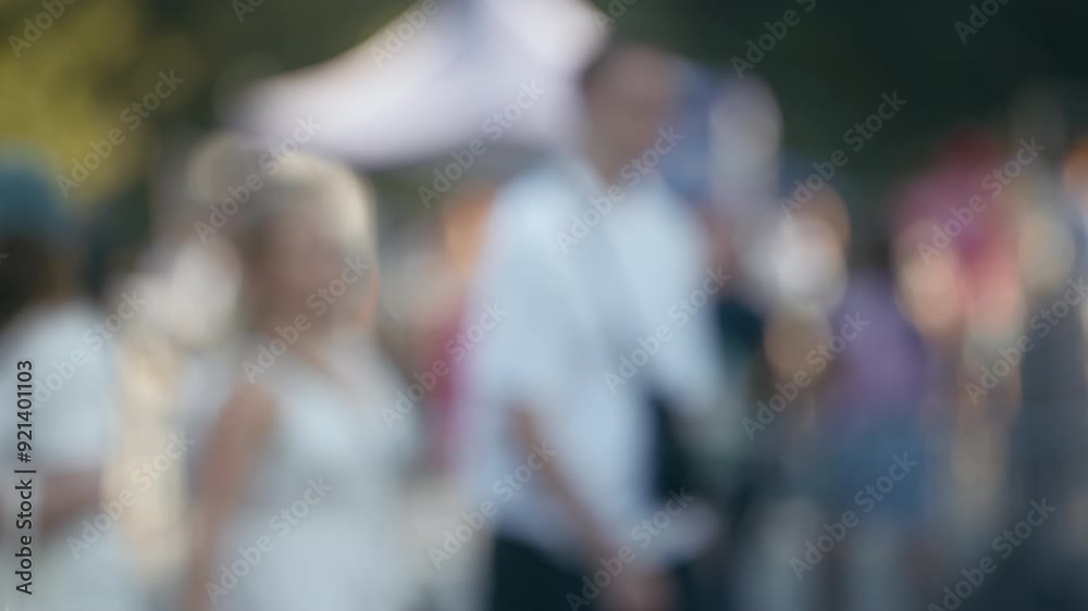Bokeh blurred people crowd walking busy street slow motion shot, city life, lot of unrecognizable pedestrians, brightly lit crowded sidewalk, urban background, rush hour summer day. Warm sunlight Bokeh blurred people crowd walking busy street slow motion shot, city life, lot of unrecognizable pedestrians, brightly lit crowded sidewalk, urban background, rush hour summer day. Warm sunlight